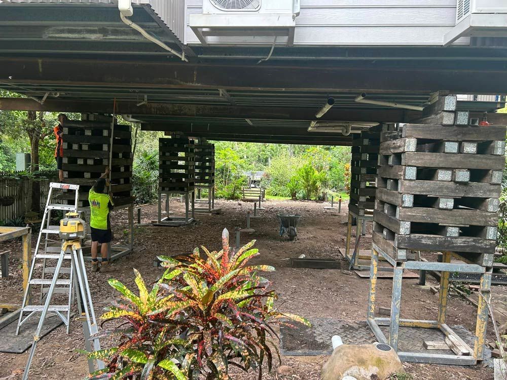 People Working on Raising a House — House Lifting Services in Garbutt, QLD