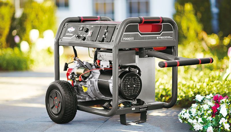 A Generator is Sitting on a Sidewalk in Front of a House — Jacksons Mower Centre in Mackay, QLD