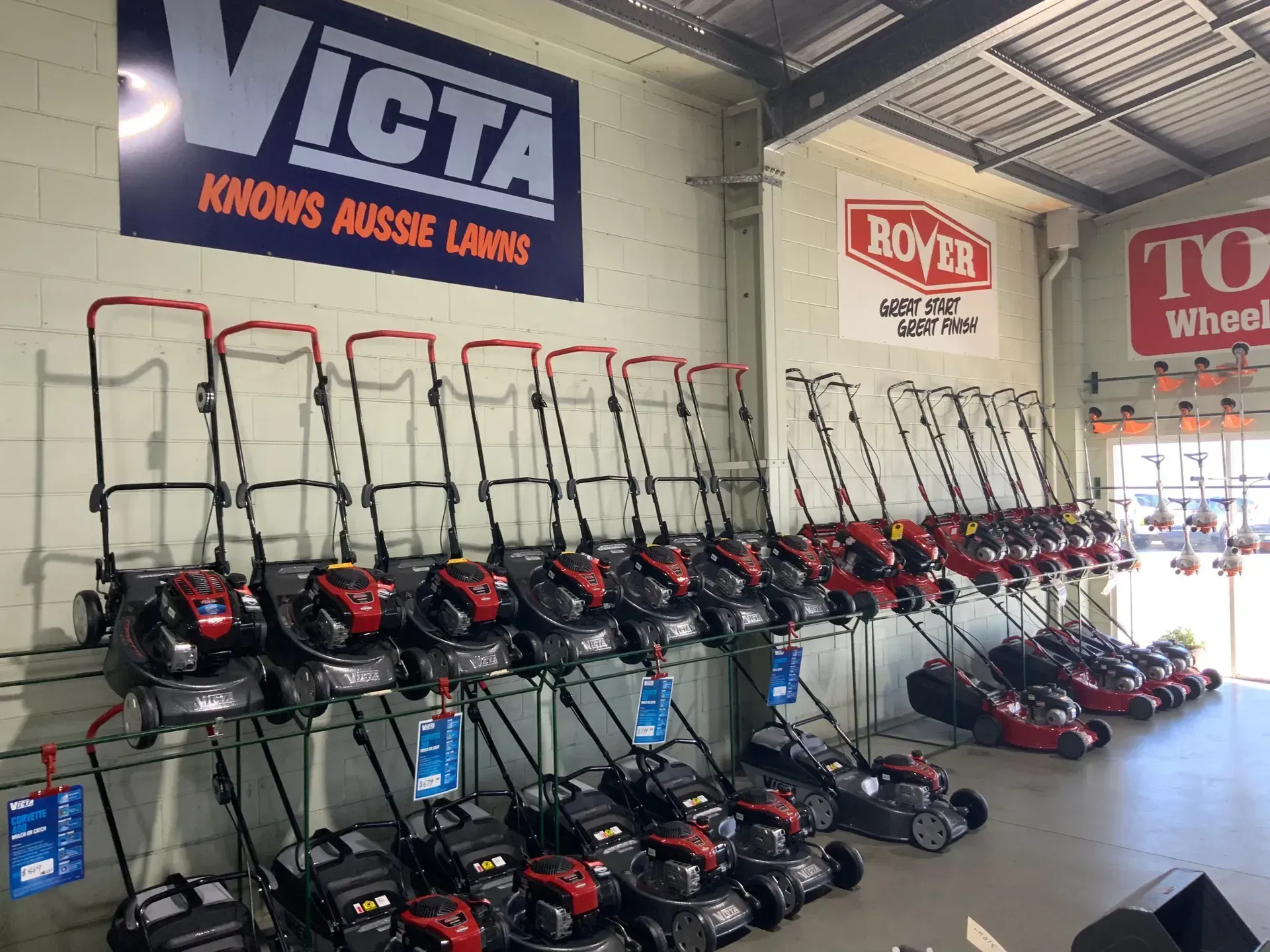 A Row of Lawn Mowers Are Lined Up in a Store — Jacksons Mower Centre in Mackay, QLD