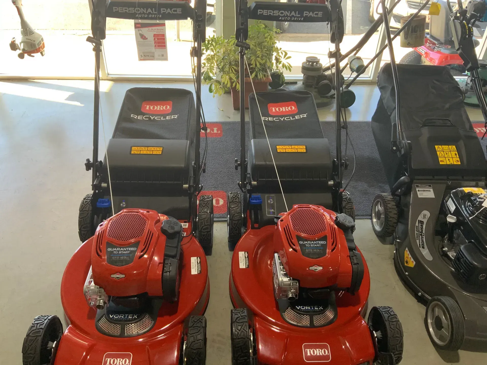 Two Toro Lawn Mowers Are on Display in a Store — Jacksons Mower Centre in Mackay, QLD