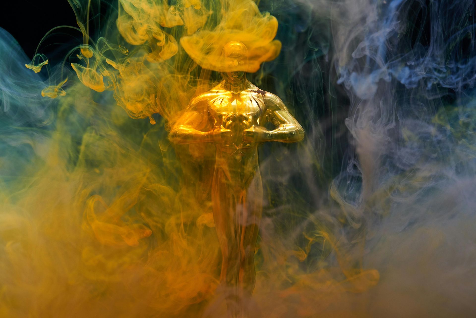 The oscar statue is surrounded by yellow and blue smoke. SEO Expert