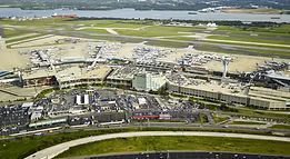An aerial view of an airport with a lot of planes on the runways.