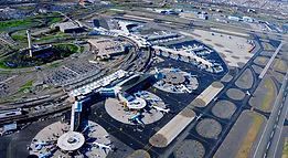 An aerial view of an airport with planes parked on the tarmac.