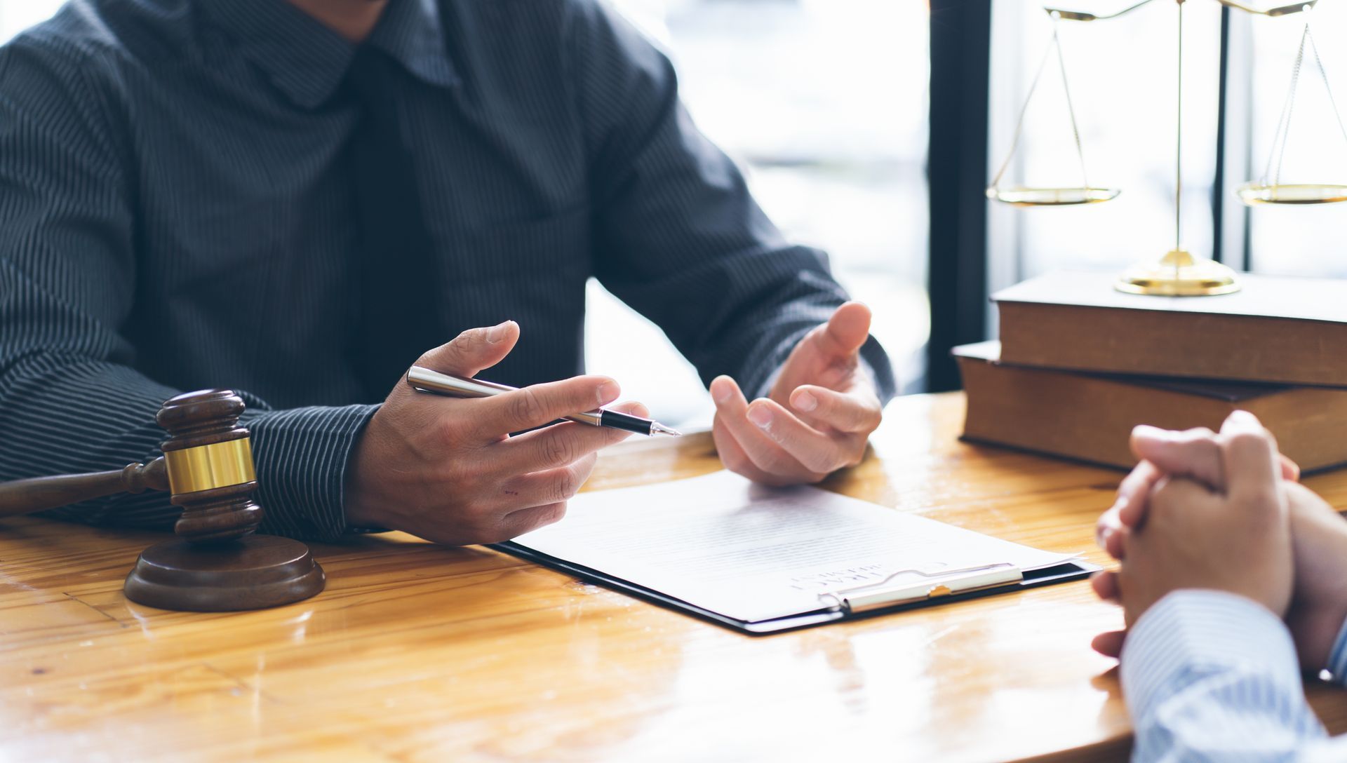 Businessman and lawyer discuss the contract document.