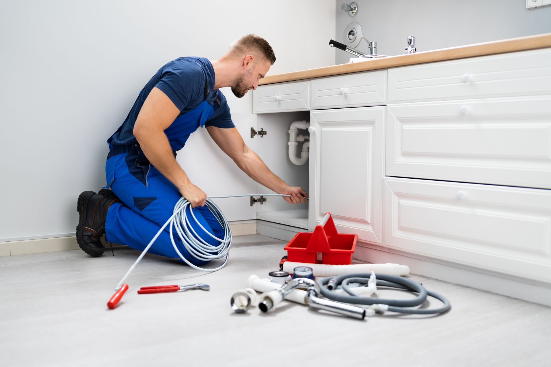 Plumber completing drain cleaning service in Woburn, MA