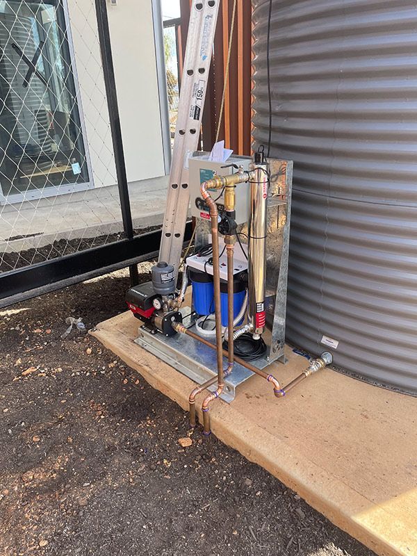 A Ladder Is Sitting Next to A Water Tank — BJB Plumbing & Gasfitting in Coonabarabran, NSW