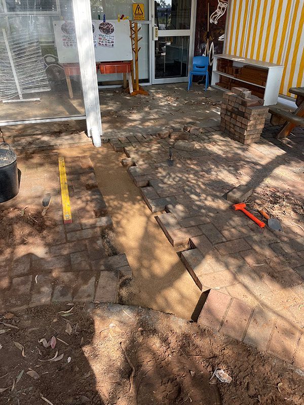 A Brick Walkway Is Being Built in Front of A Building — BJB Plumbing & Gasfitting in Bourke, NSW