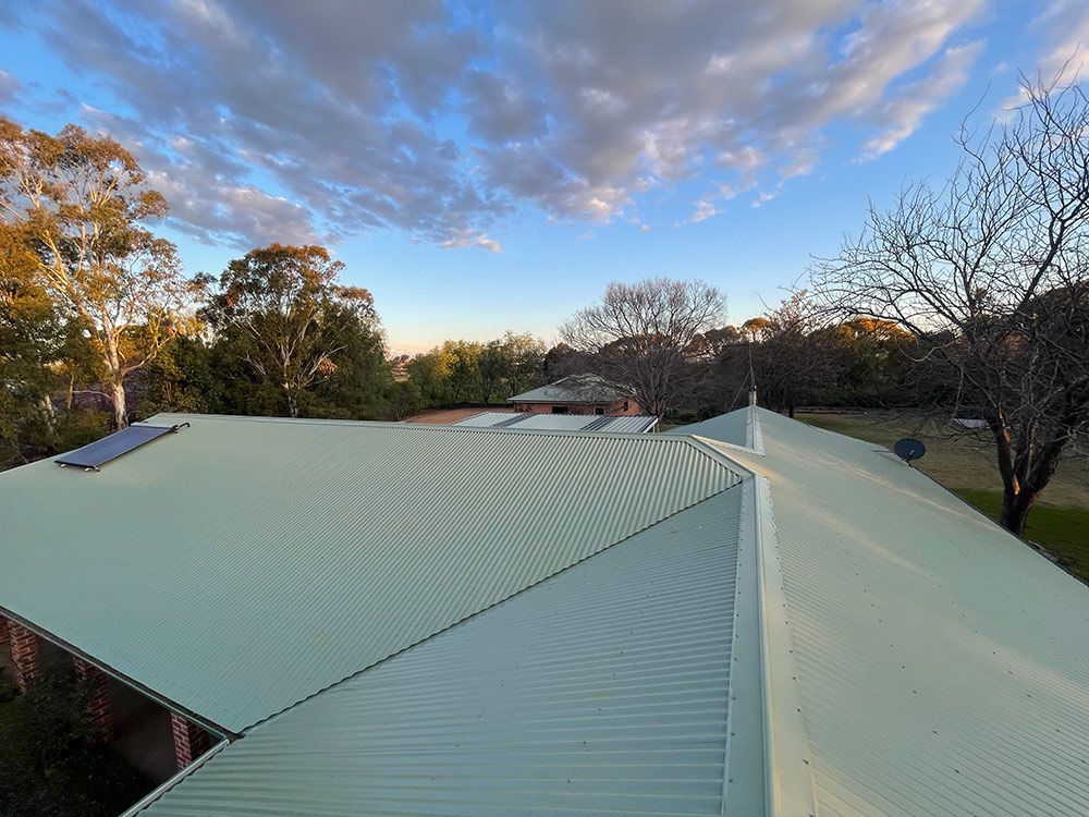 An Aerial View of A Roof of A House with Trees in The Background — BJB Plumbing & Gasfitting in Parkes, NSW