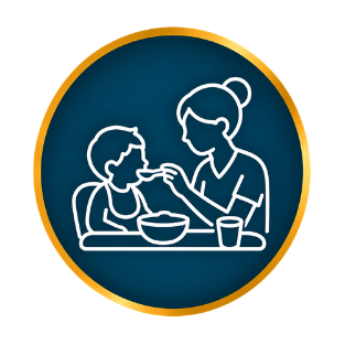 White line drawing of a caregiver feeding a child at a table inside a blue-and-gold circle