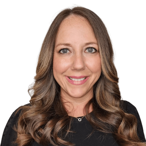 Smiling woman with long wavy brown hair wearing a black top on a white background