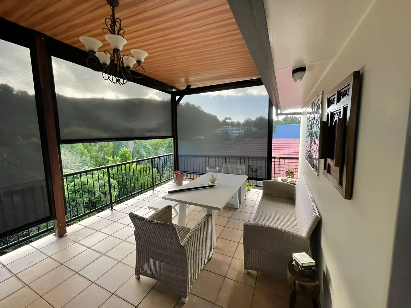 A Balcony With a Table and Chairs on It — Dennys Upholstery & Outdoor Blinds In Ballina, NSW