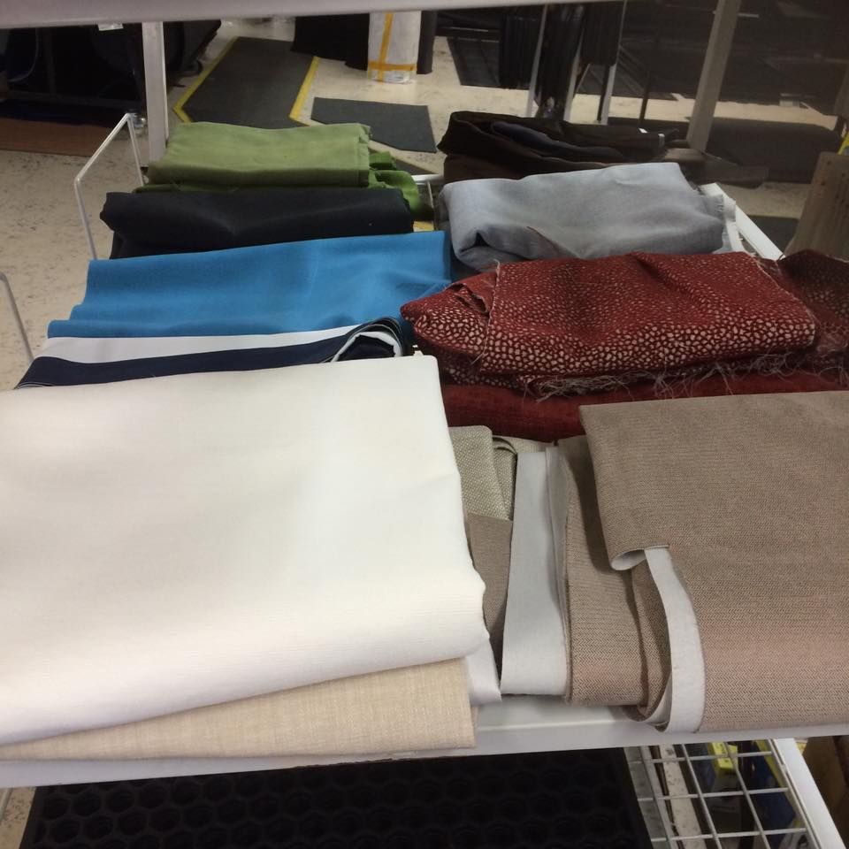 A Bunch of Fabrics Are Stacked on Top of Each Other — Dennys Upholstery & Outdoor Blinds In Byron, NSW
