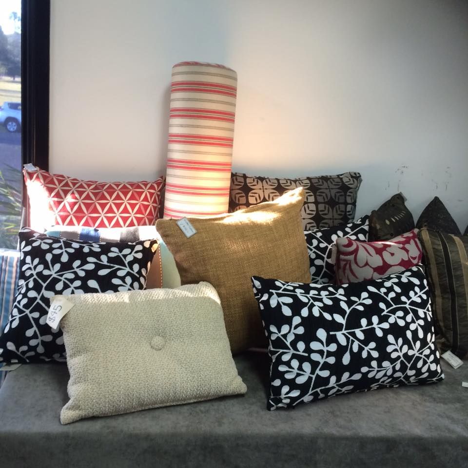 A Bunch of Pillows Are Sitting on a Table — Dennys Upholstery & Outdoor Blinds In Lismore, NSW