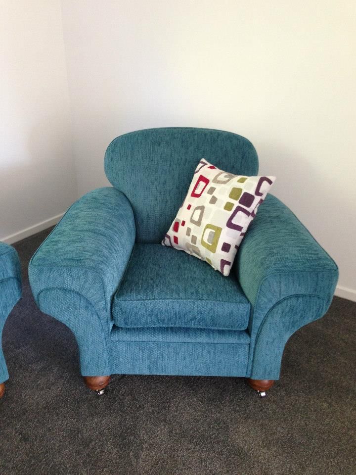 A Blue Chair With a Colourful Pillow on It — Dennys Upholstery & Outdoor Blinds In Lismore, NSW