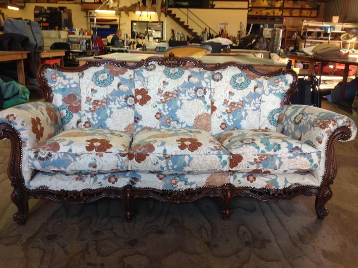 A Floral Couch is Sitting on a Rug in a Room — Dennys Upholstery & Outdoor Blinds In Evans Head, NSW