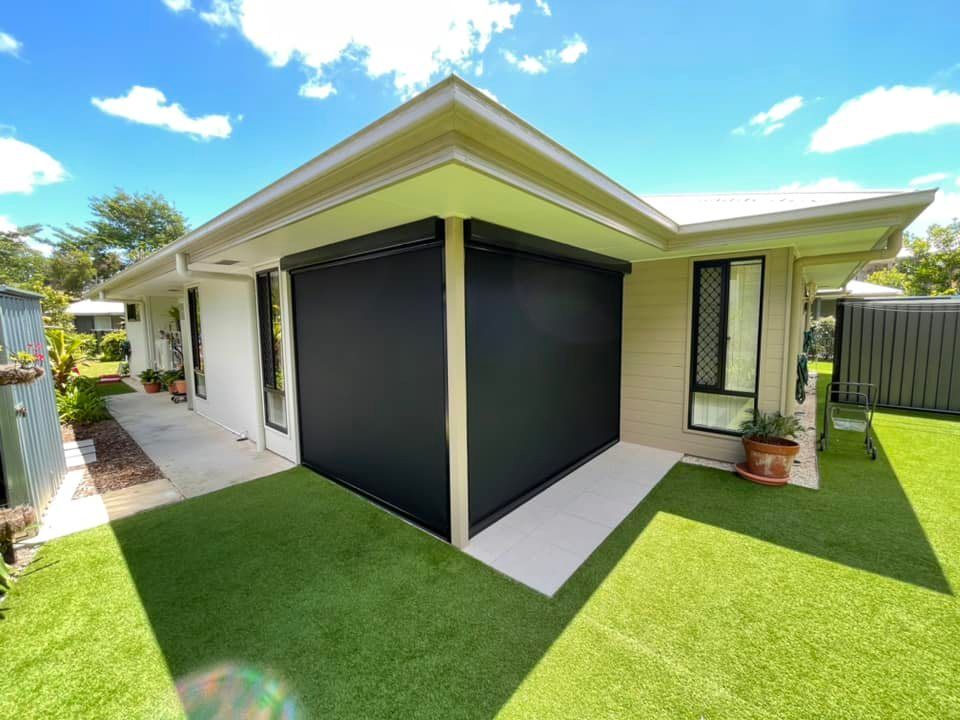 A House With a Black Screen on the Side of It — Dennys Upholstery & Outdoor Blinds In Lismore, NSW
