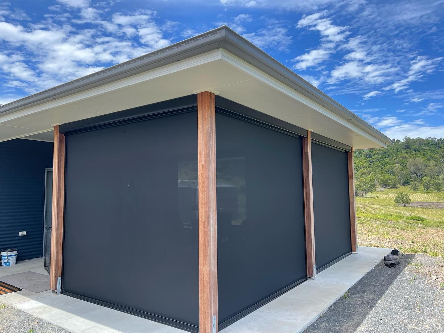 A House With a Black Awning on the Side of It — Dennys Upholstery & Outdoor Blinds In Evans Head, NSW