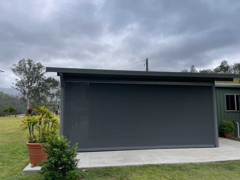 A Shed With a Large Screen on the Side of It — Dennys Upholstery & Outdoor Blinds In Casino, NSW