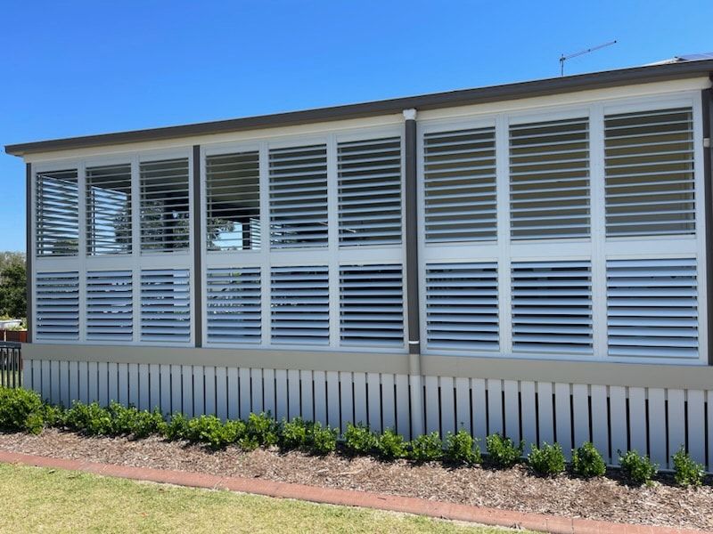 A House With a Lot of Windows and Shutters — Dennys Upholstery & Outdoor Blinds In Lismore, NSW