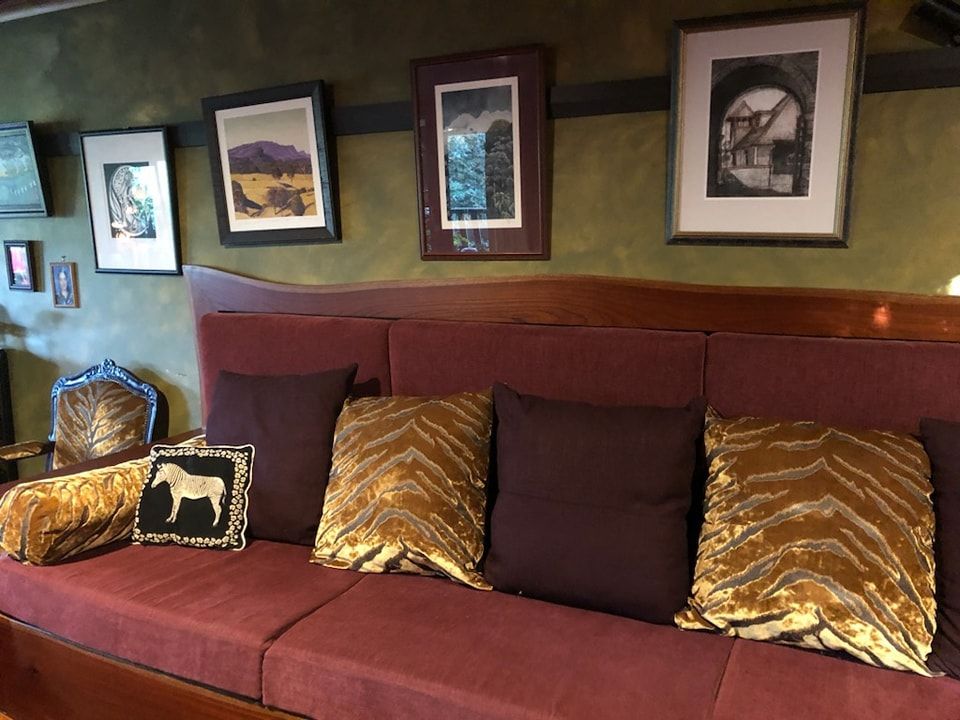 A Couch With a Horse Pillow on It — Dennys Upholstery & Outdoor Blinds In Byron, NSW