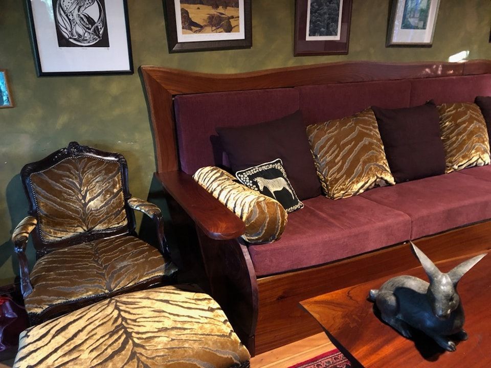 A Living Room With a Purple Couch and Gold Pillows — Dennys Upholstery & Outdoor Blinds In Casino, NSW