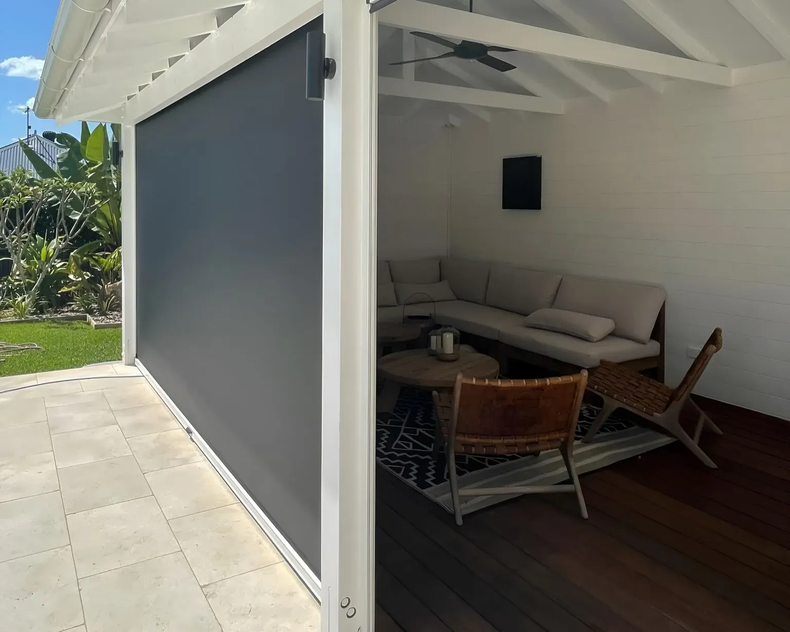 A Black Leather Couch is Sitting on Top of a Cow Print Rug — Dennys Upholstery & Outdoor Blinds In South Lismore, NSW