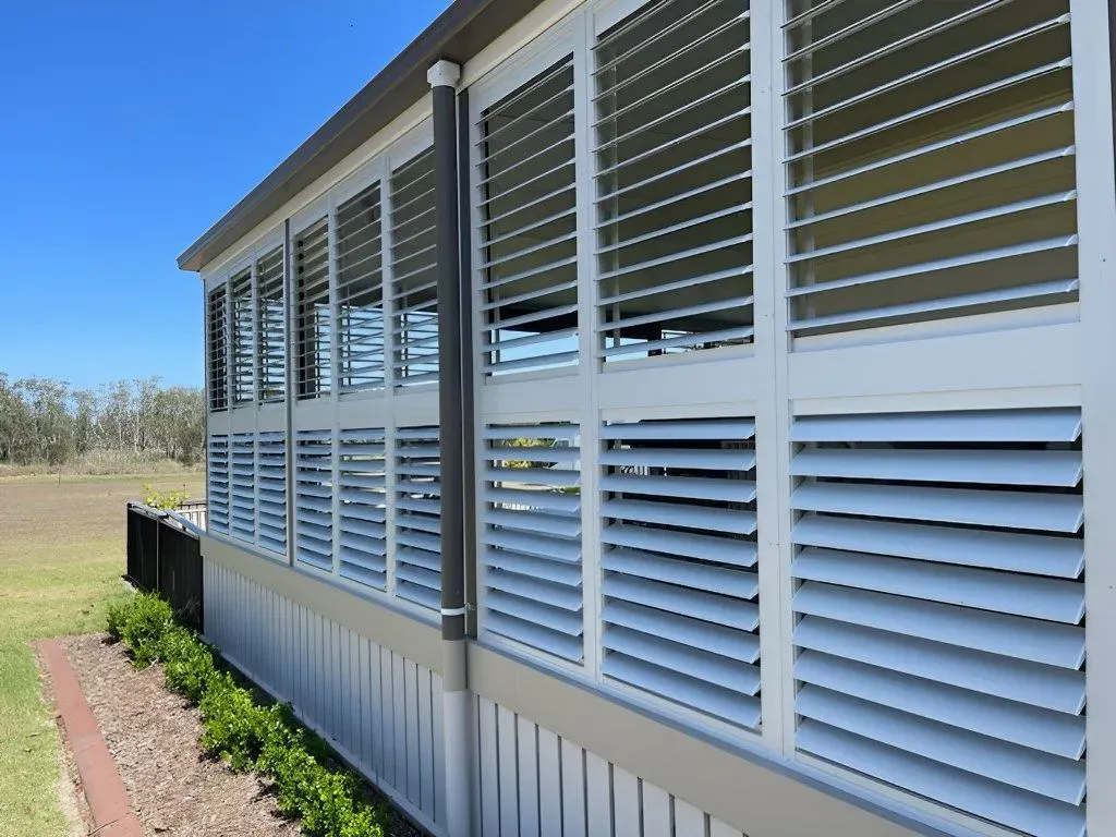 A House With a Lot of Shutters on the Windows — Dennys Upholstery & Outdoor Blinds In South Lismore, NSW