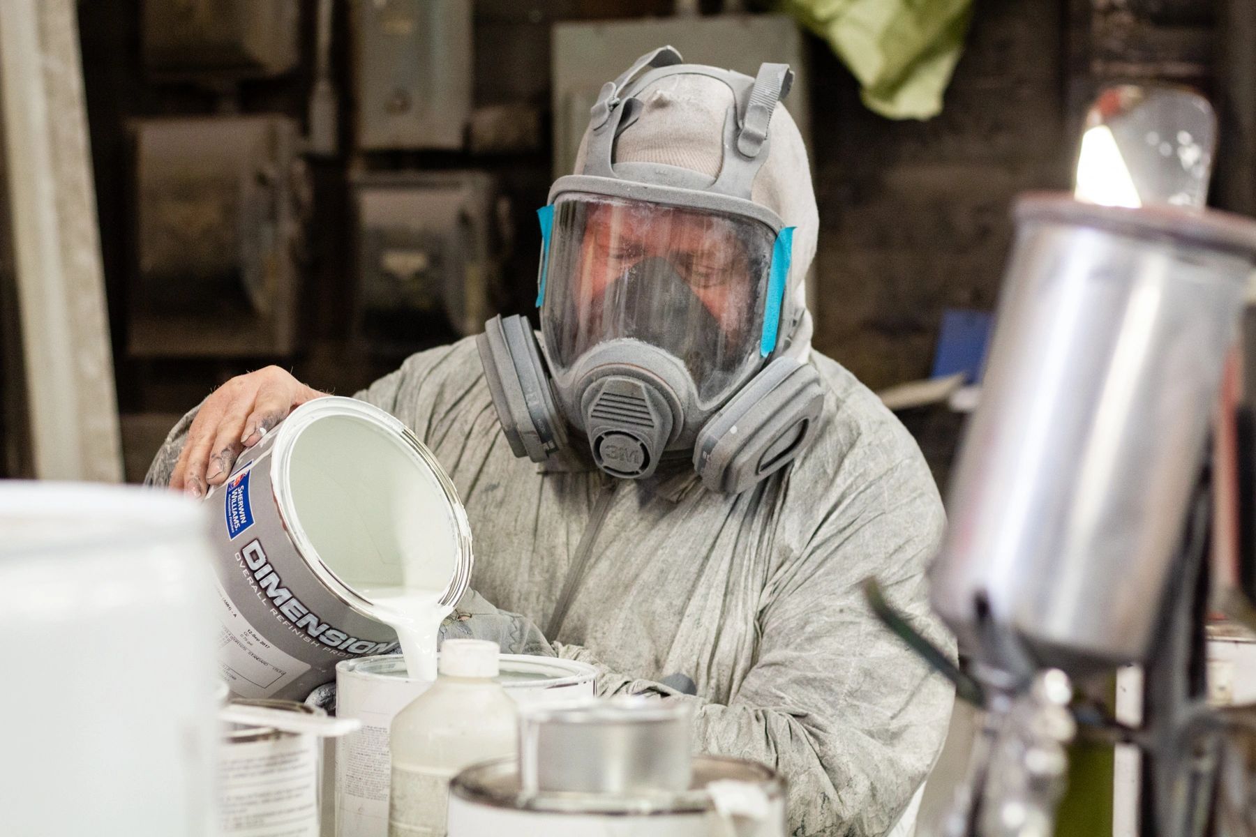 Man Pouring Car Paint — Louisville, KY — AL Hansen Paint & Metal Shop Inc