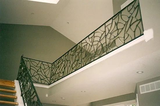 A staircase with a wrought iron railing in a house