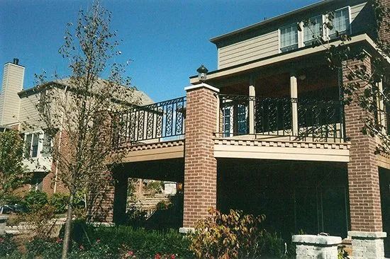 A large brick house with a balcony on the second floor