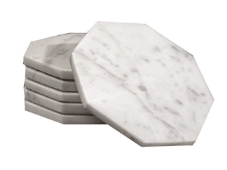 A stack of white marble coasters on a white background