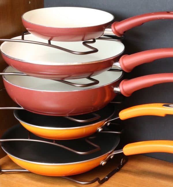 Four pans are stacked on top of each other on a rack