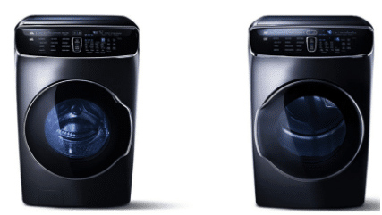 Two black washing machines are sitting next to each other on a white background.