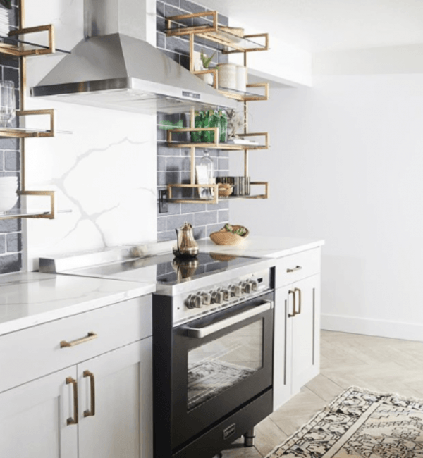 A kitchen with a black stove and white cabinets
