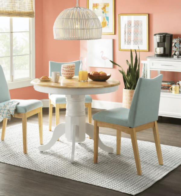 A dining room with a round table and chairs