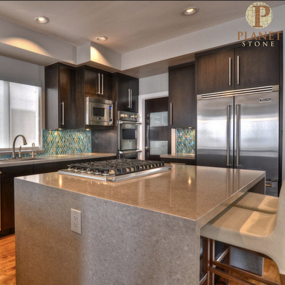 A kitchen with a stove top oven and a stainless steel refrigerator