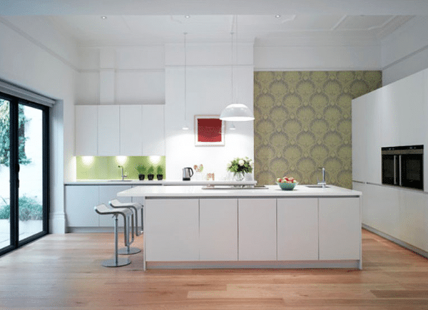 A kitchen with white cabinets and a large island in the middle