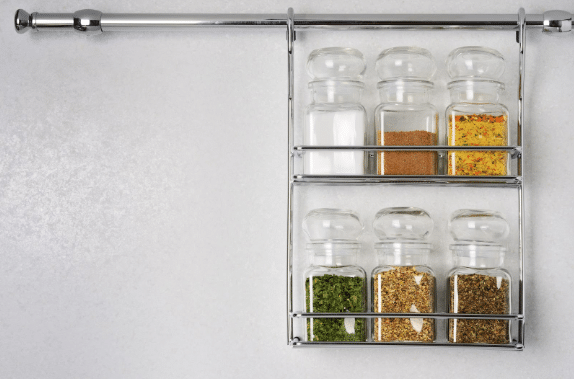 A spice rack with jars of spices on it