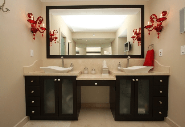 A bathroom with two sinks and a large mirror