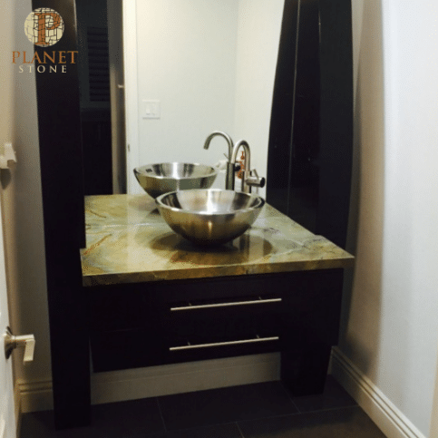 A bathroom with two sinks and a planet stone sign
