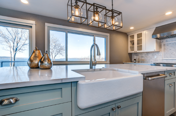 A kitchen with a large sink and a large window.