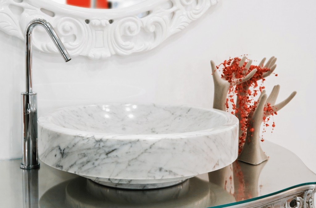 A bathroom with a marble sink and a mirror