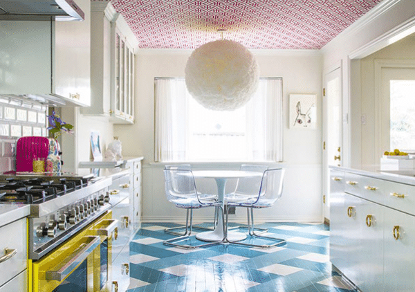 A kitchen with a blue and white checkered floor and a pink ceiling.