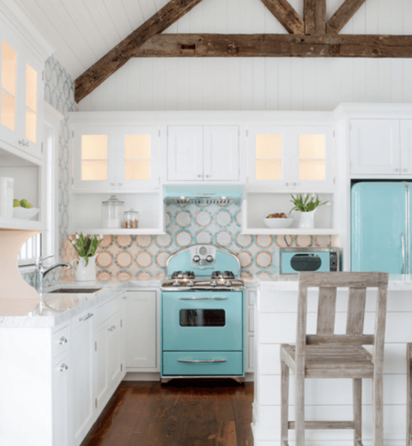 A kitchen with a blue stove and white cabinets