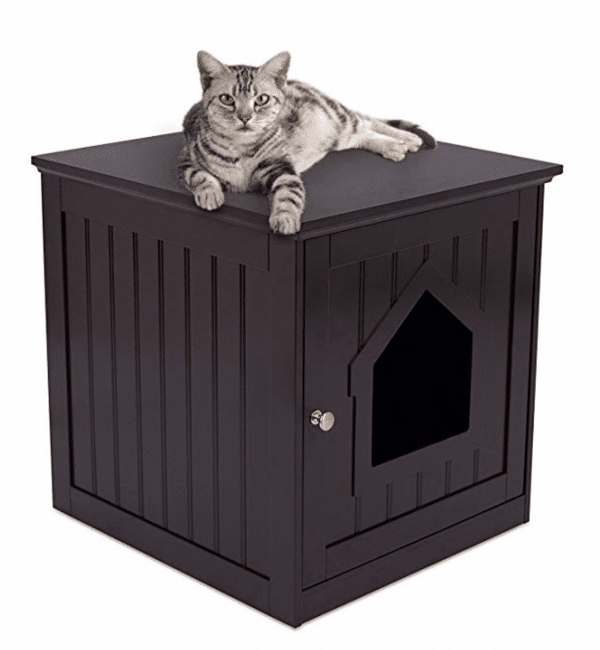 A cat is laying on top of a black cat house