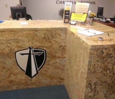 A christian school logo is on a counter