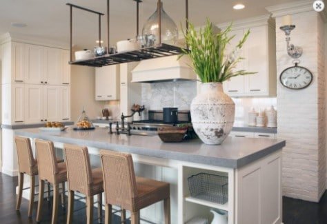 A kitchen with a large island and a clock on the wall