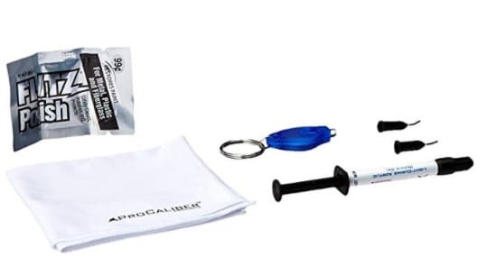 A white towel , a syringe , a keychain , and a bag of floss polish.