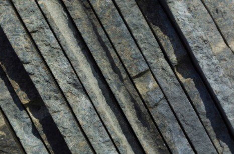 A close up of a row of wooden sticks stacked on top of each other.