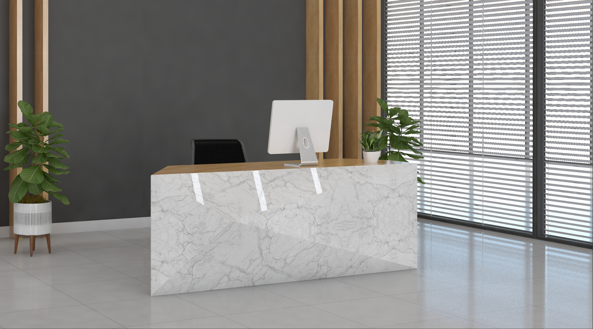 A reception desk with a computer on it in a lobby.